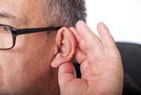 Man holding ear to listen